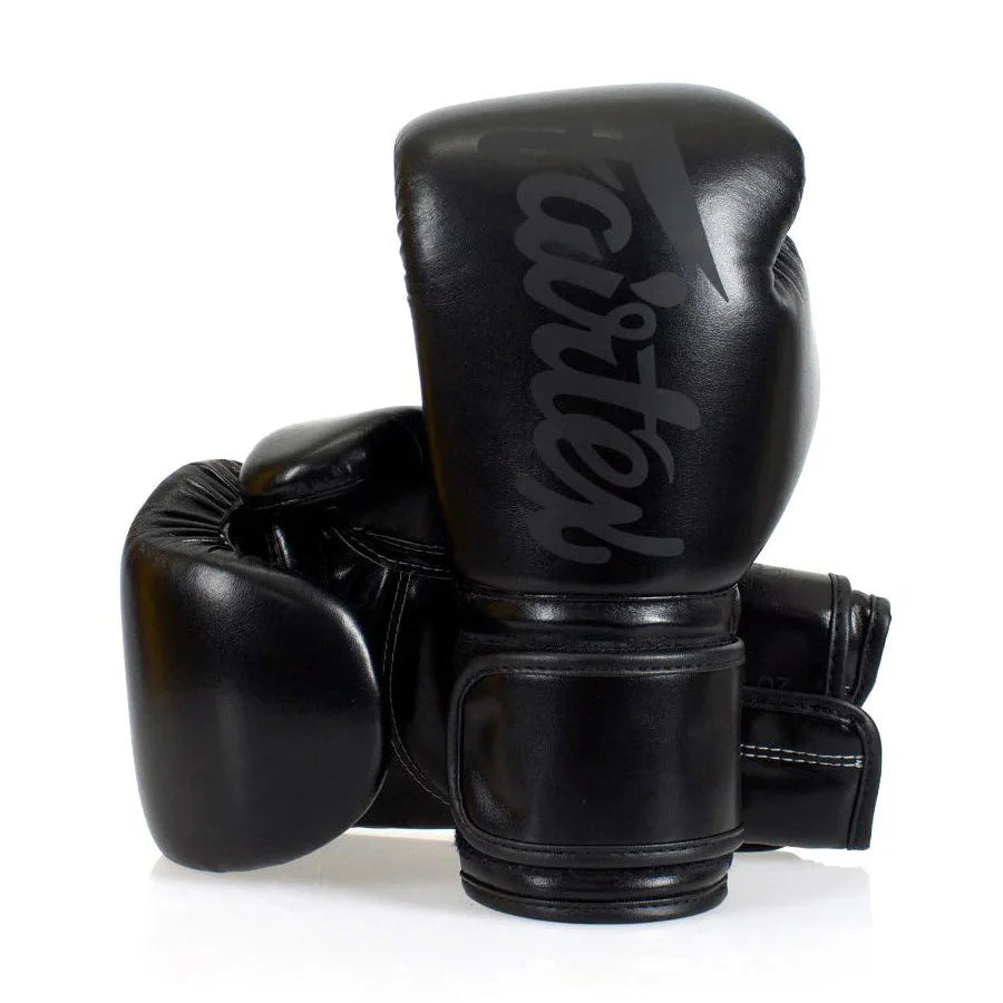 Black boxing gloves with 'Fairtex' branding on a white background
