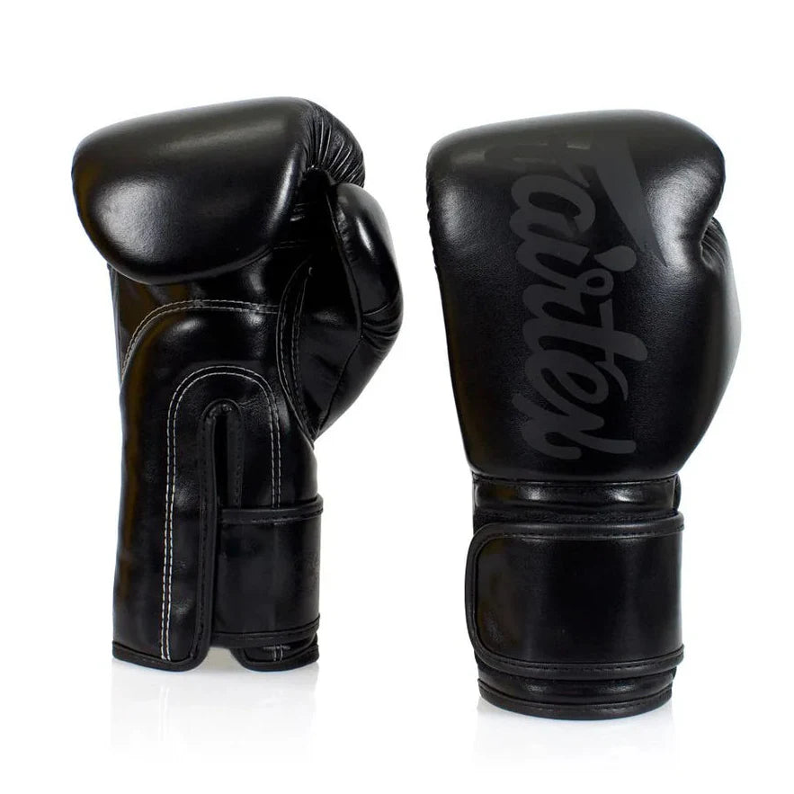 Pair of black boxing gloves with 'Fairtex' branding on a white background