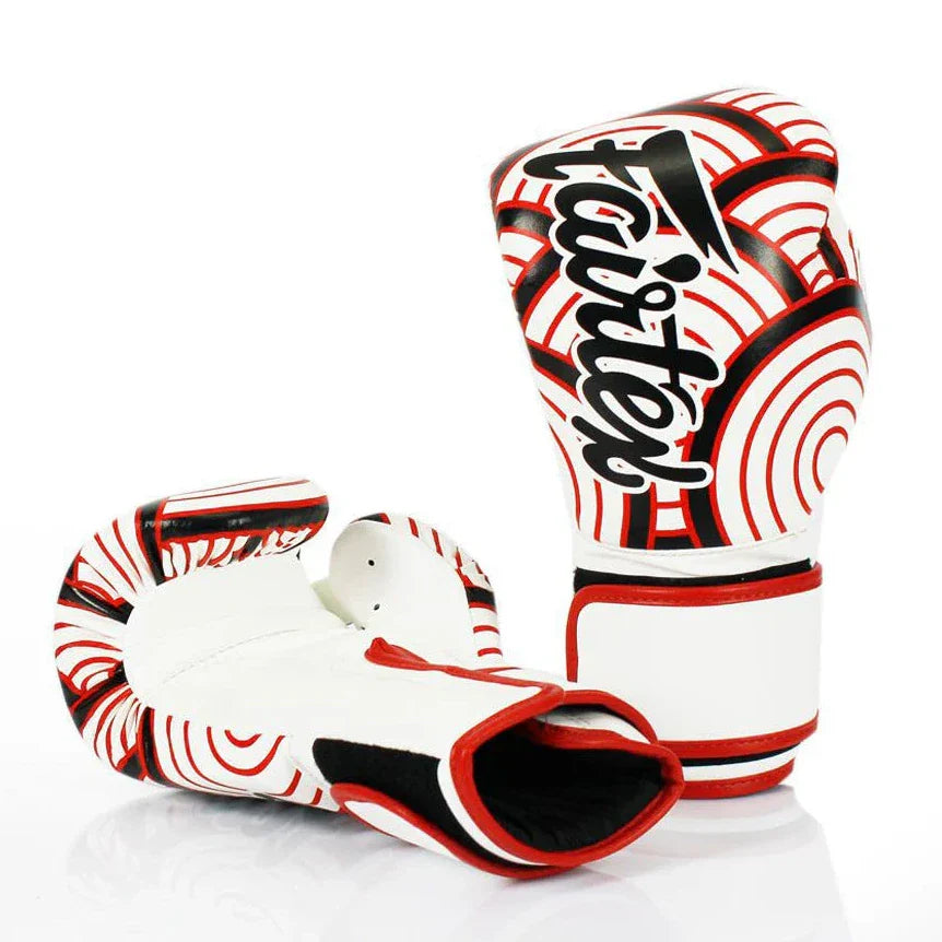 Pair of white boxing gloves with red and black patterns on a white background