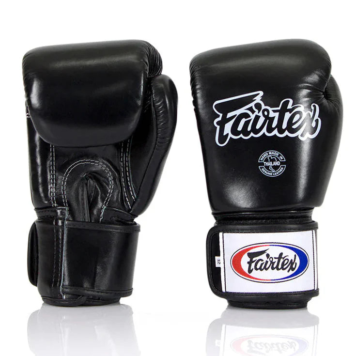 Black boxing gloves with Fairtex logo on a white background