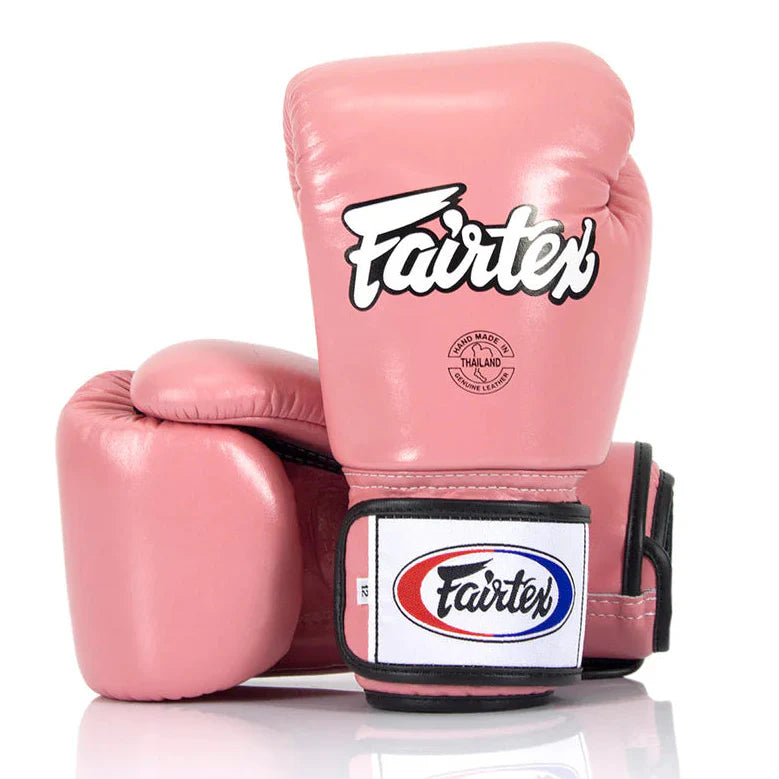 Pink boxing gloves with Fairtex logo on a white background