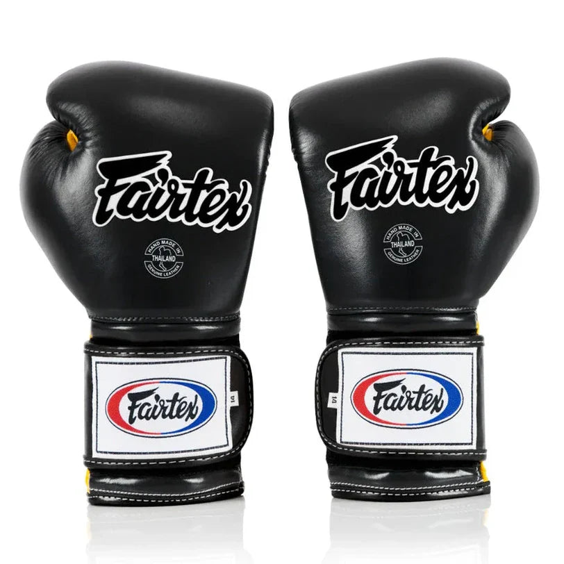 Pair of black Fairtex boxing gloves on a white background