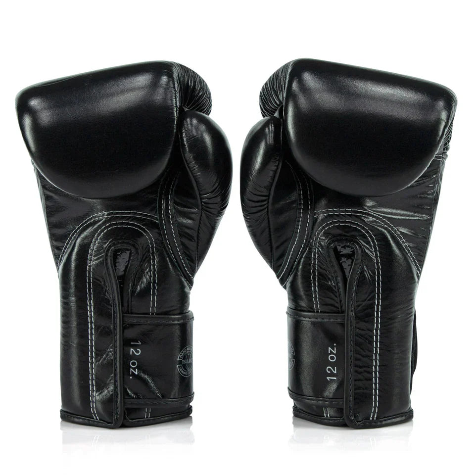 Pair of black boxing gloves on a white background