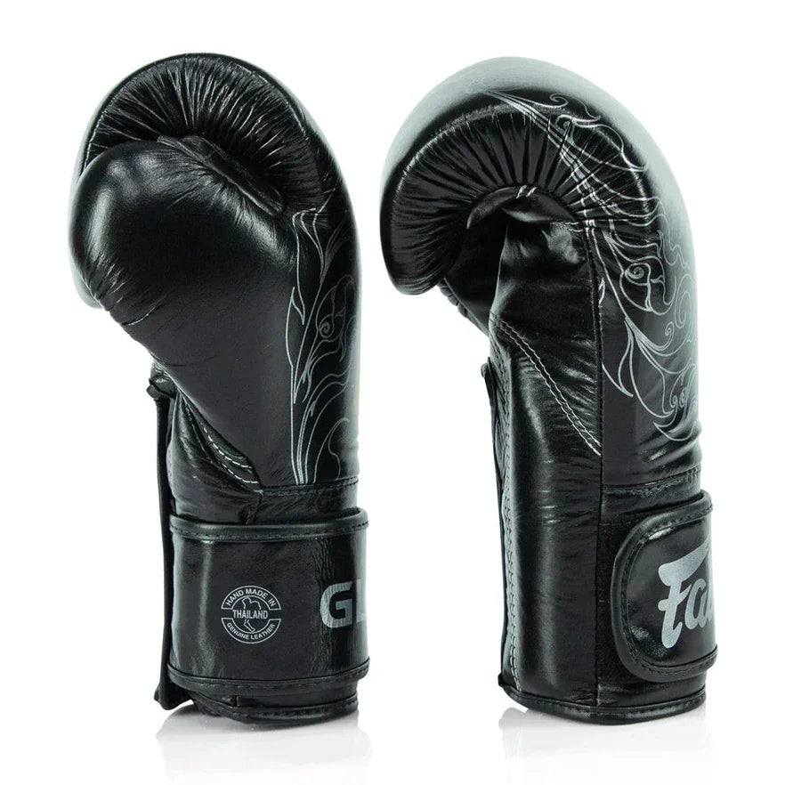Black boxing gloves with white designs on a white background