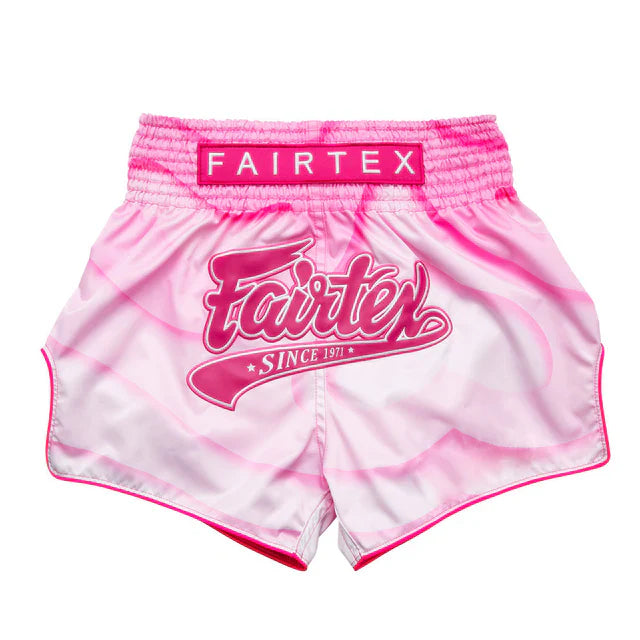 Pink and white Muay Thai shorts with Fairtex logo on a white background
