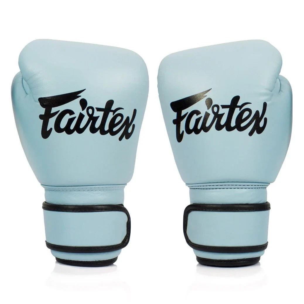 Pair of light blue boxing gloves with Fairtex logo on a white background