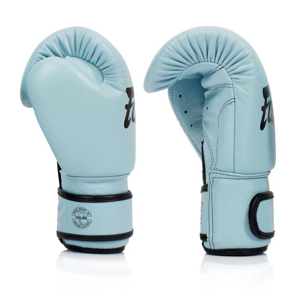Pair of light blue boxing gloves with black accents on a white background