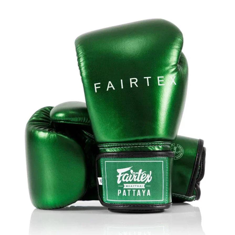 Green Fairtex boxing gloves on a white background