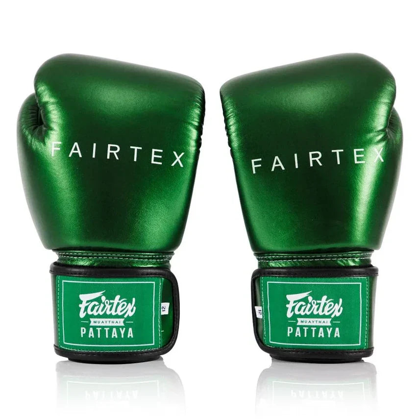 Pair of green Fairtex boxing gloves on a white background