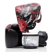 Black boxing glove with red and white floral and snake design on a white background