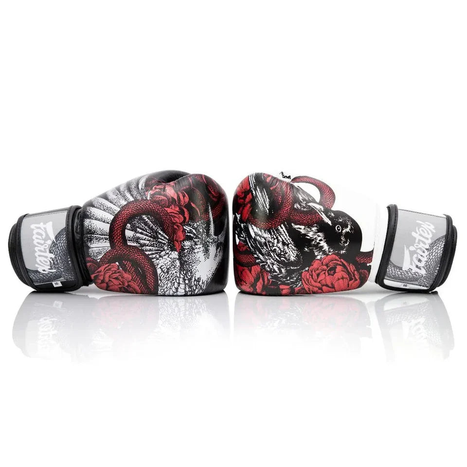 Pair of boxing gloves with red and black design on a white background