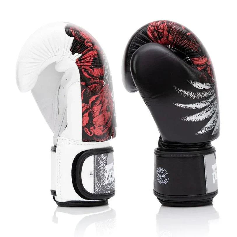 Pair of boxing gloves with red and black design on a white background
