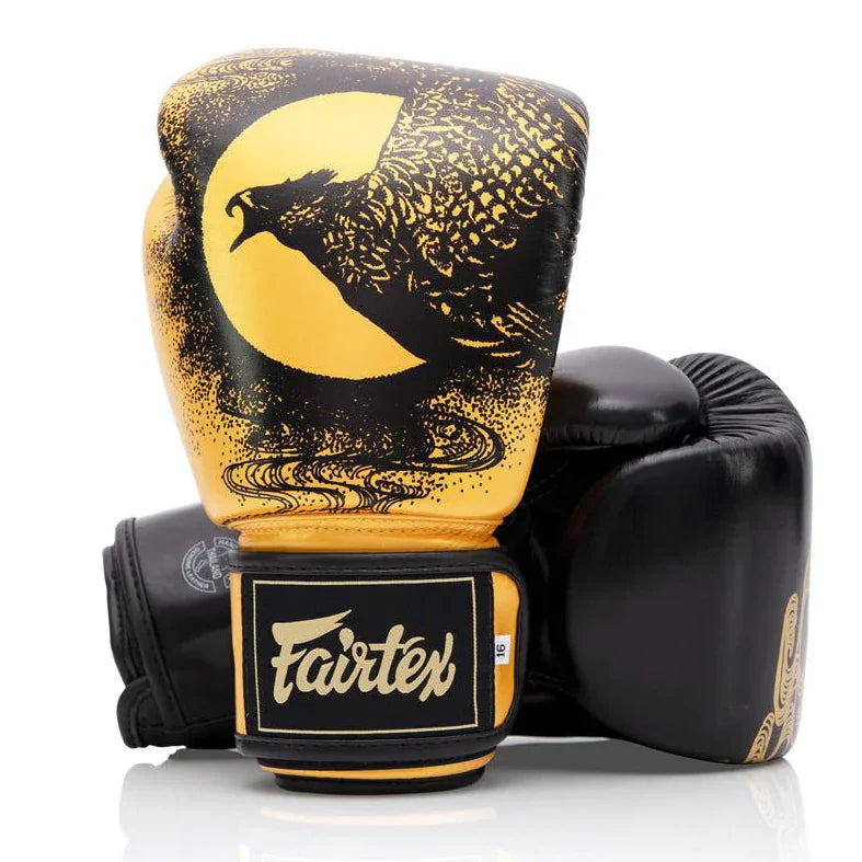 Black and gold boxing glove with eagle design and Fairtex branding on a white background