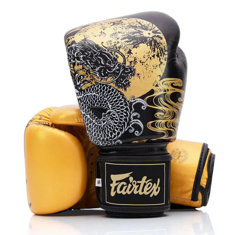 Pair of boxing gloves with dragon design and Fairtex branding on a white background