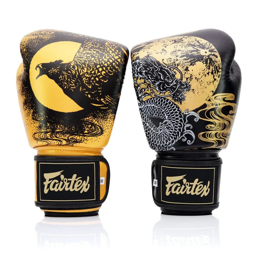 Pair of Fairtex boxing gloves with dragon and moon design on a white background