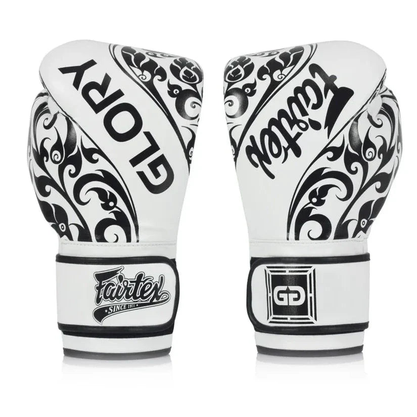 Pair of white boxing gloves with black patterns and Fairtex branding on a white background