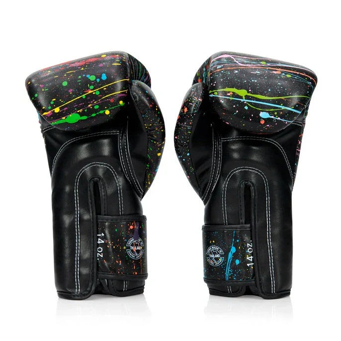 Pair of black boxing gloves with colorful splatter design on a white background