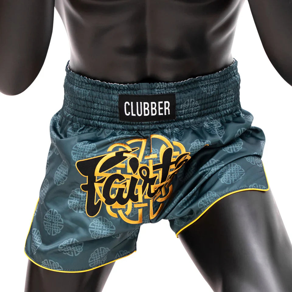 Teal Muay Thai shorts with 'CLUBBER' and 'Fairtex' branding on a mannequin.