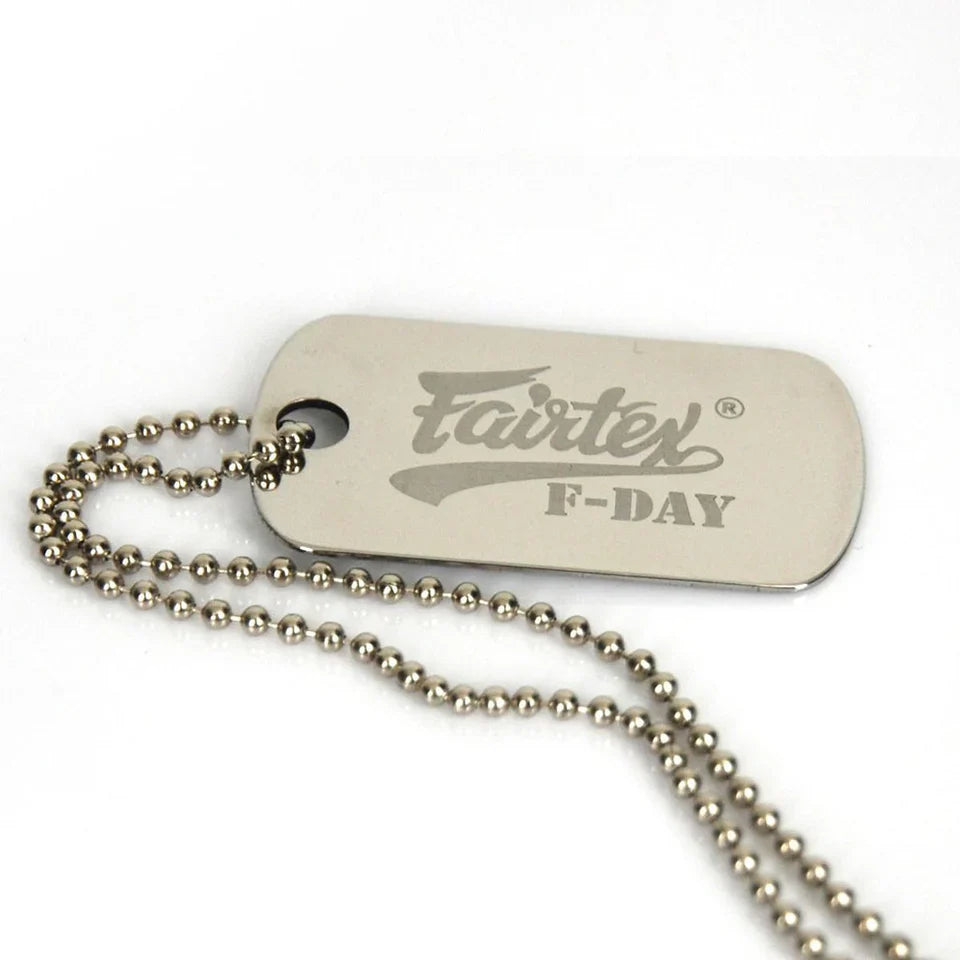 Metal dog tag with 'Fairtex' branding on a white background