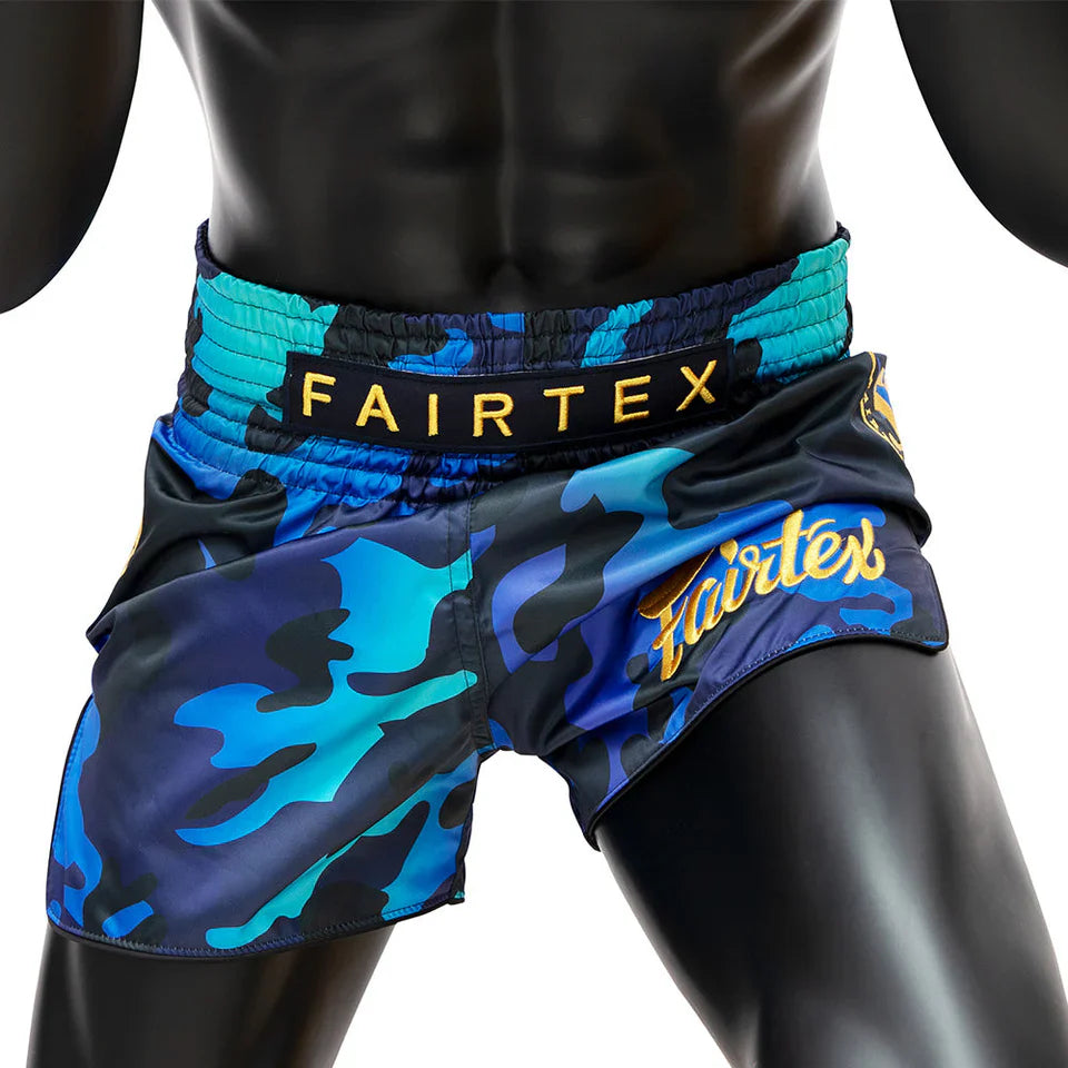Blue camouflage Muay Thai shorts with Fairtex branding on a white background
