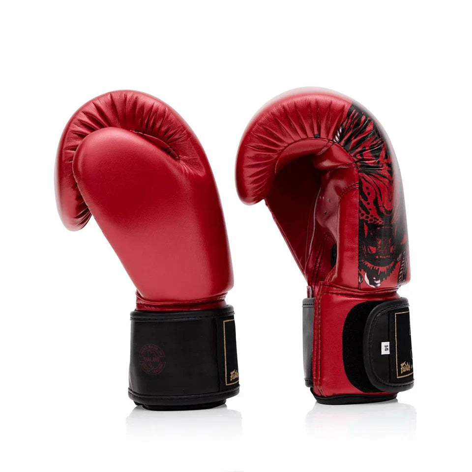 Red boxing gloves with black accents on a white background