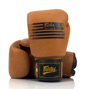 Pair of brown boxing gloves with Fairtex branding on a white background