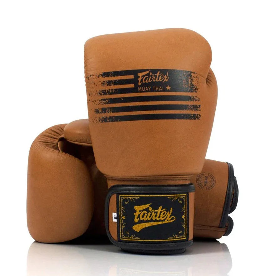 Pair of brown boxing gloves with Fairtex branding on a white background