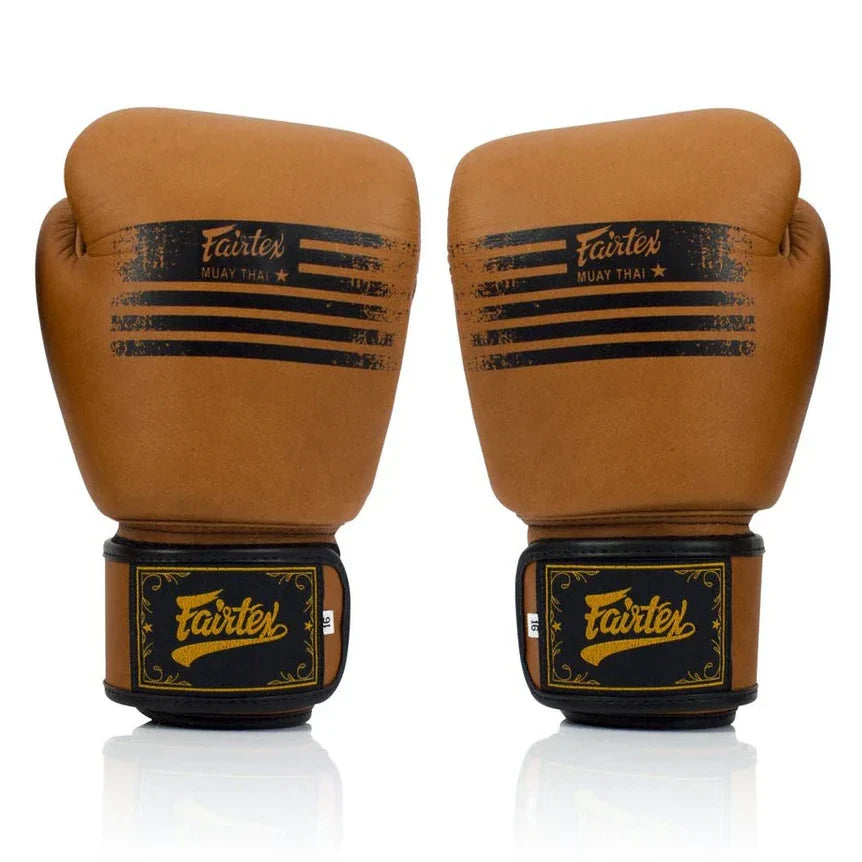 Pair of brown boxing gloves with Fairtex branding on a white background