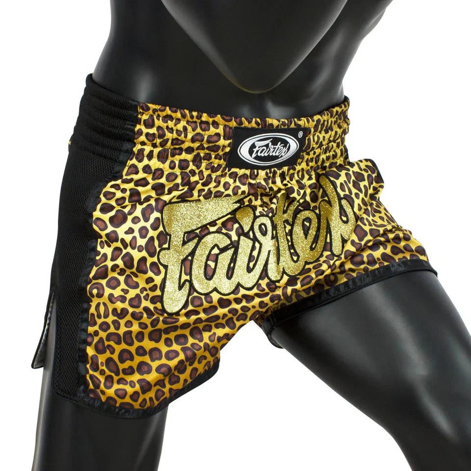 Leopard print Muay Thai shorts with 'Fairtex' branding on a mannequin.