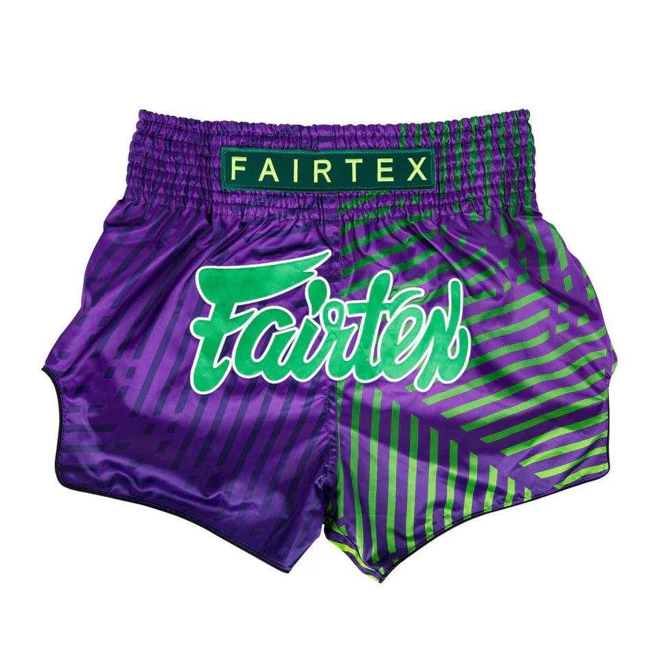 Purple and green Fairtex Muay Thai shorts on a white background