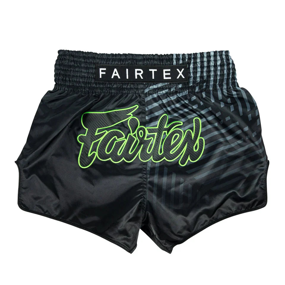 Black Fairtex Muay Thai shorts with green logo on a white background
