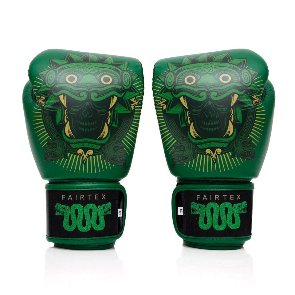 Green boxing gloves with intricate designs on a white background, featuring the Fairtex brand.