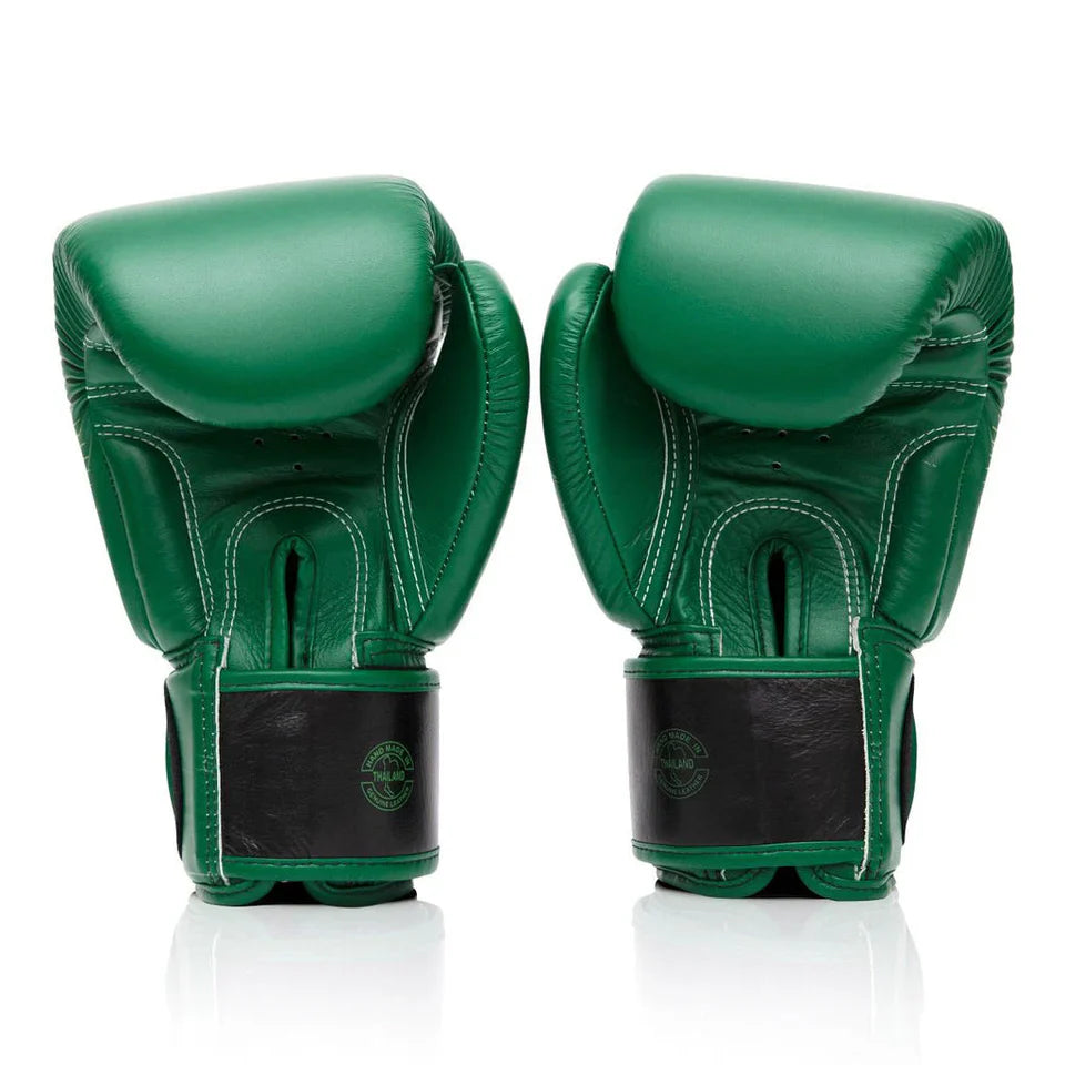 Pair of green boxing gloves on a white background