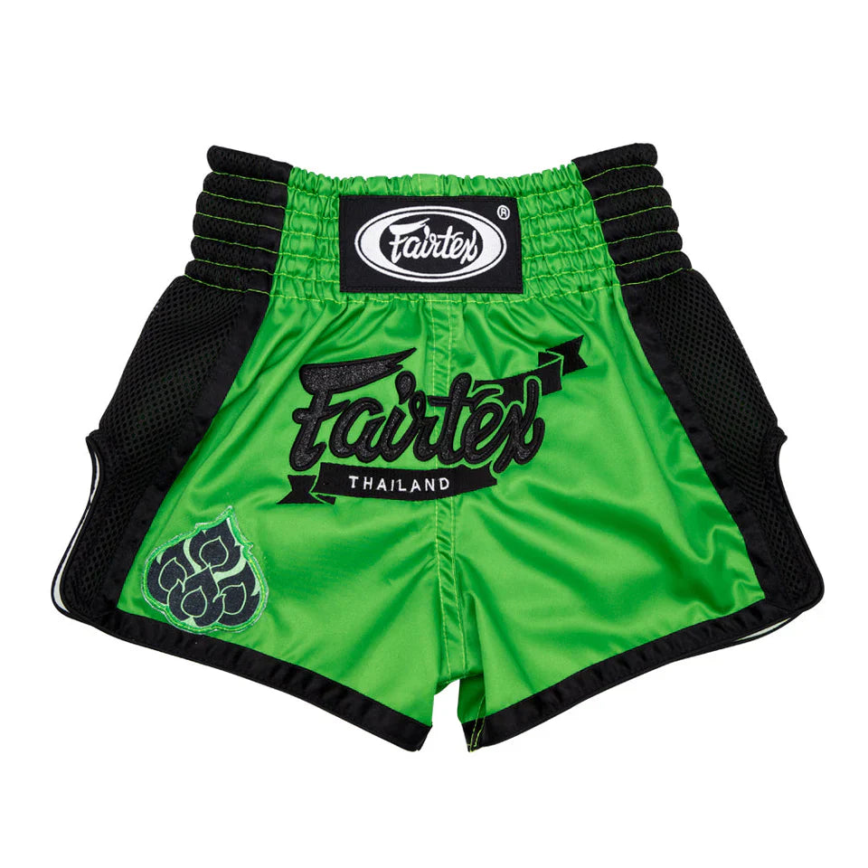 Green boxing shorts with black trim and Fairtex branding on a white background