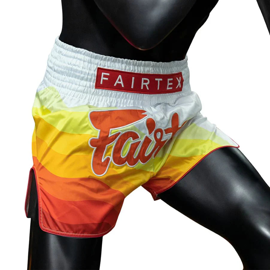 Colorful Muay Thai shorts with Fairtex branding on a mannequin.