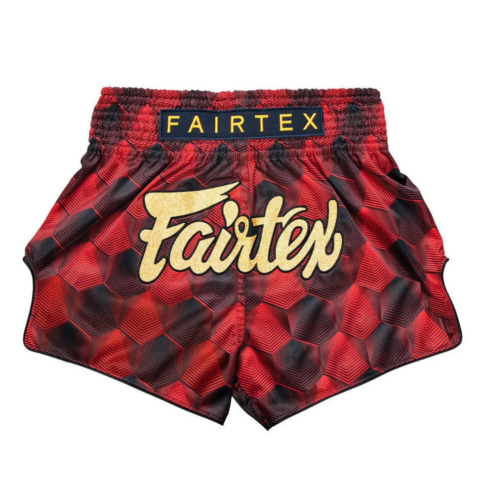 Red and black Fairtex Muay Thai shorts on a white background