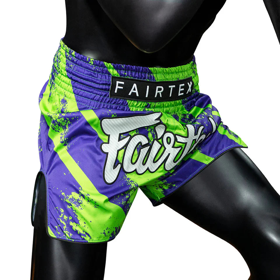 Colorful Muay Thai shorts with 'Fairtex' branding on a mannequin.