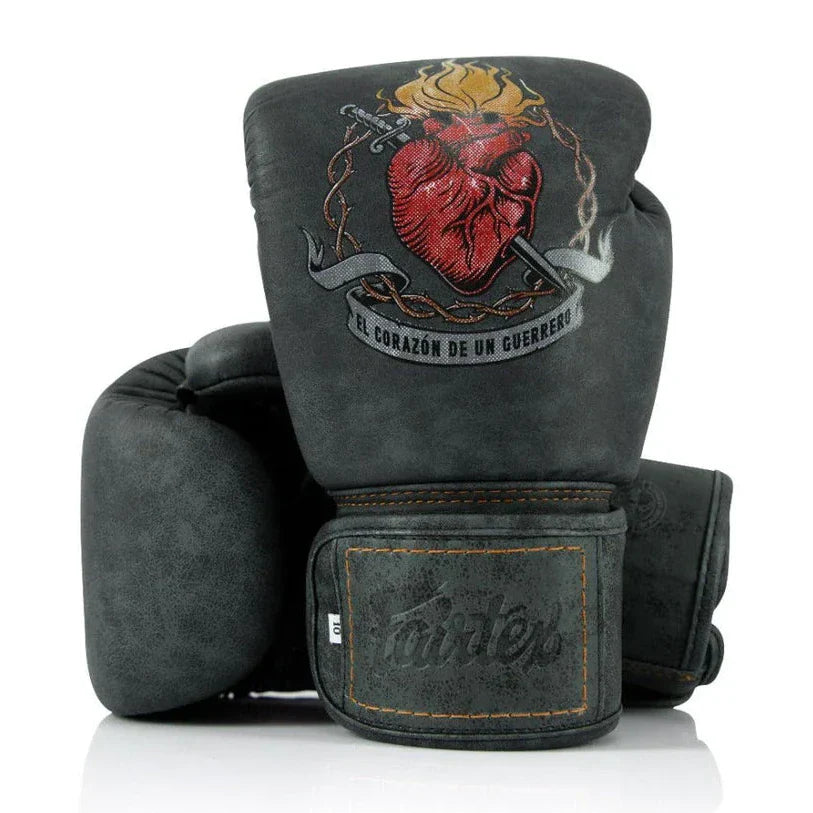 Pair of gray boxing gloves with a heart design and Fairtex logo on a white background