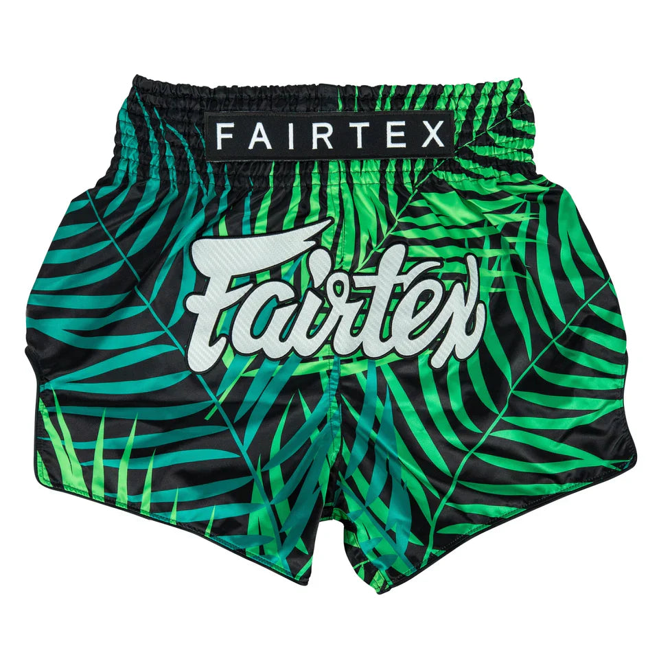 Green and black leaf-patterned boxing shorts with Fairtex branding on a white background