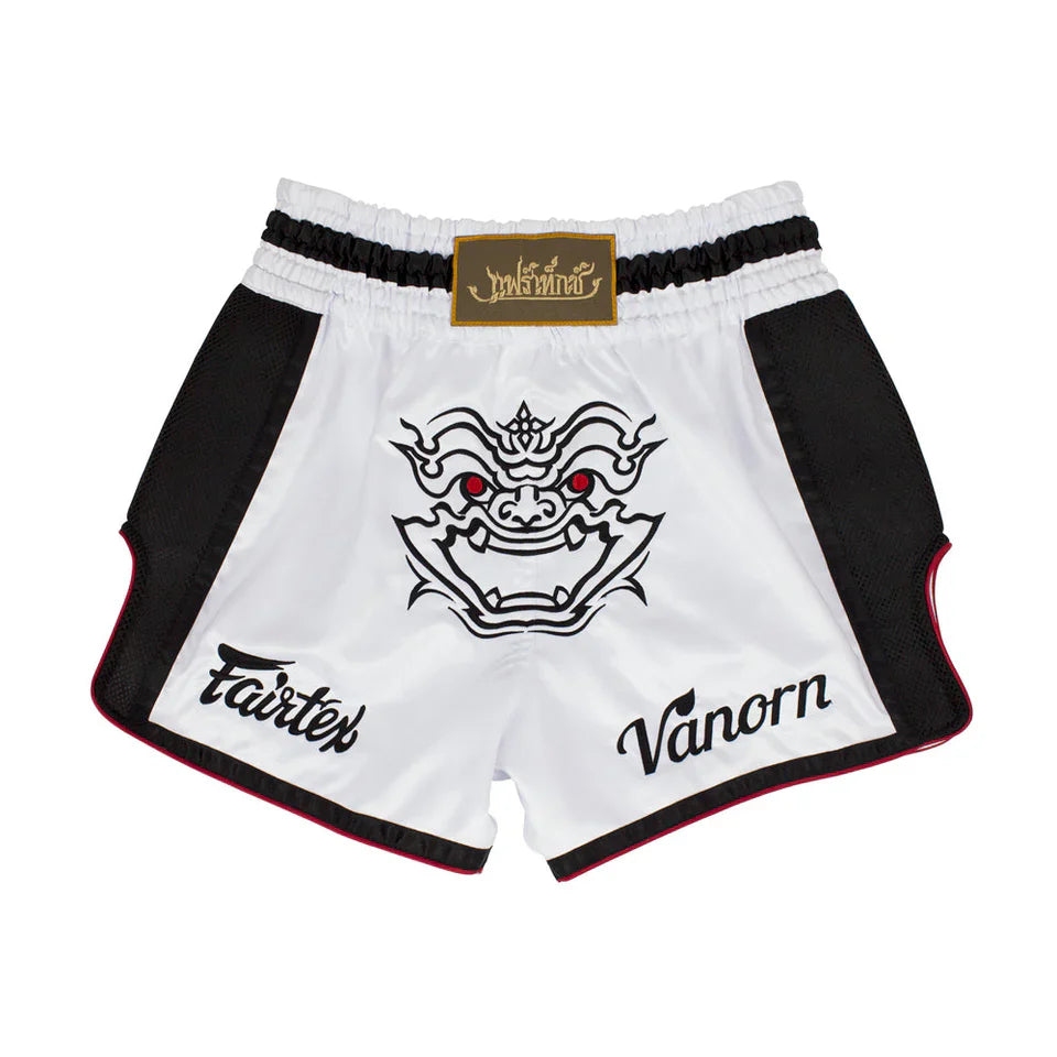 White Muay Thai shorts with black accents and a dragon design, featuring Fairtex and Vanorn logos on a white background.