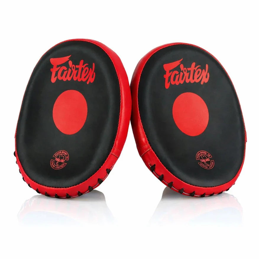 Pair of black and red Fairtex focus mitts on a white background