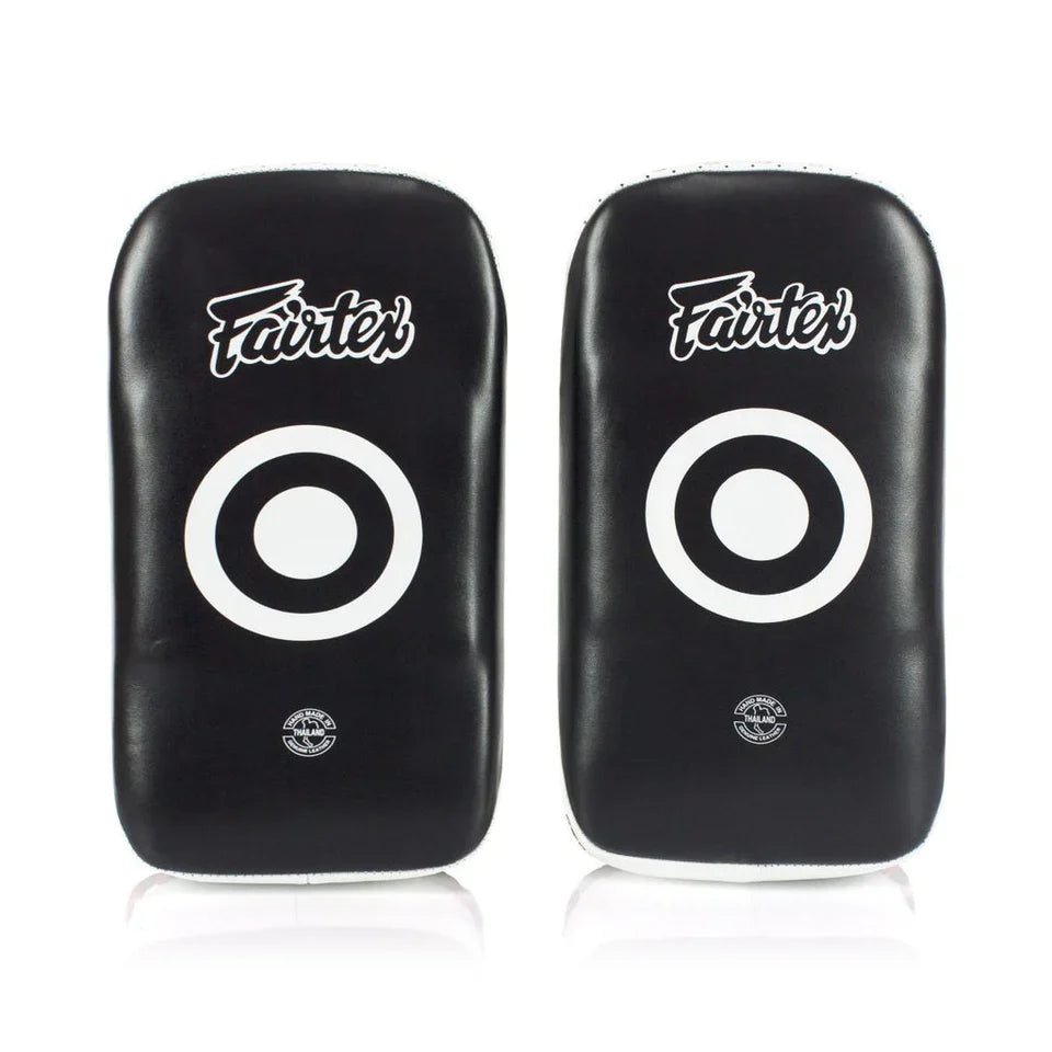 Pair of black Fairtex Muay Thai pads with white circular targets on a white background