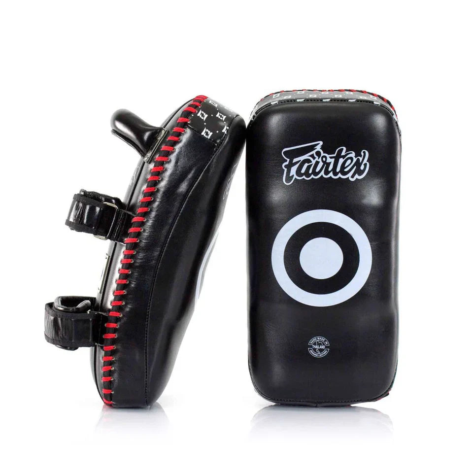 Black and red Fairtex Muay Thai pads on a white background