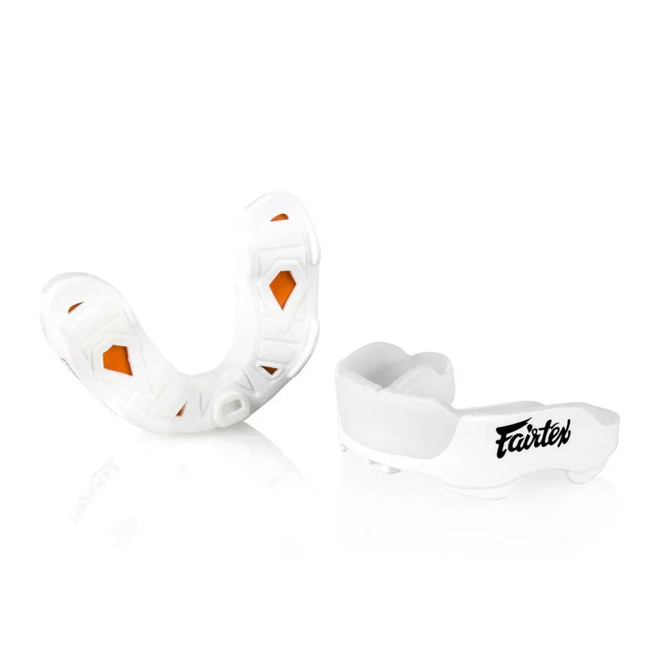White mouthguard with orange accents and 'Fairtex' branding on a white background