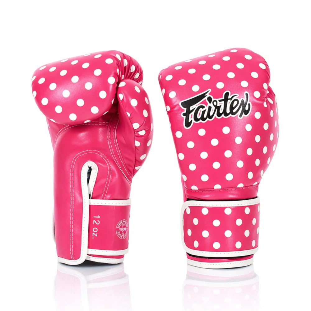 Pink boxing gloves with white polka dots and Fairtex logo on a white background