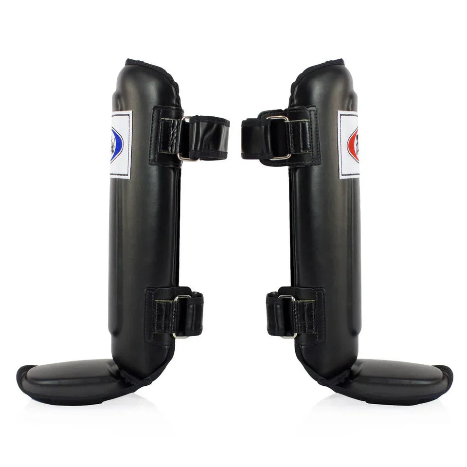 Pair of black shin guards with brand labels on a white background