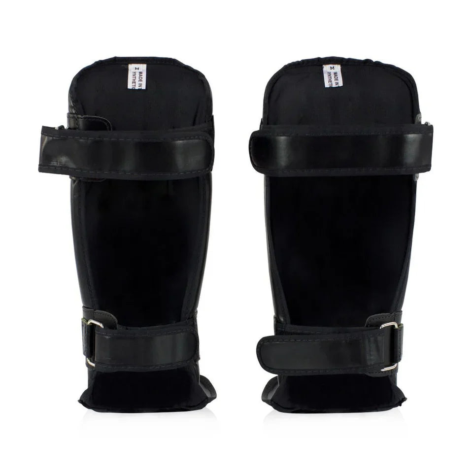 Pair of black shin guards on a white background