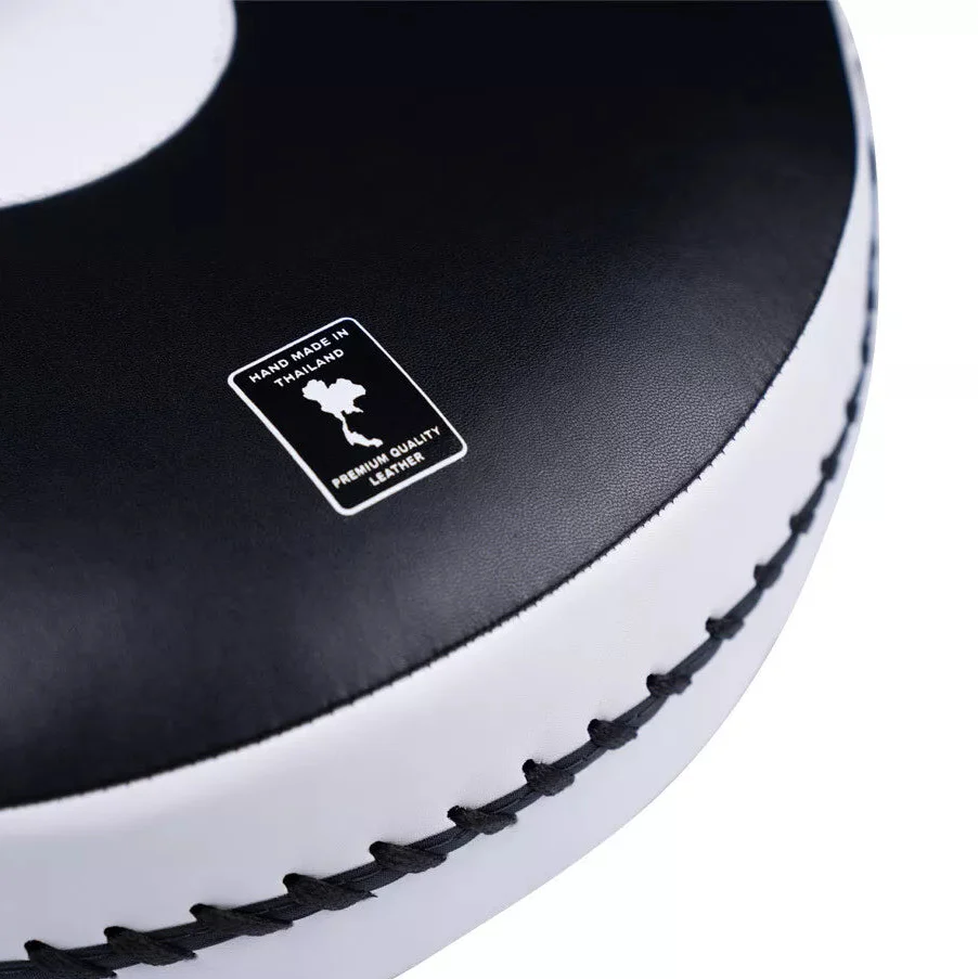 Close-up of a black and white boxing pad with a 'Hand Made in Thailand' label.