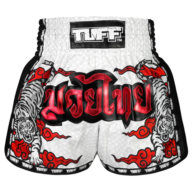 White Muay Thai boxing shorts with red and black designs and 'TUFF' branding on a white background