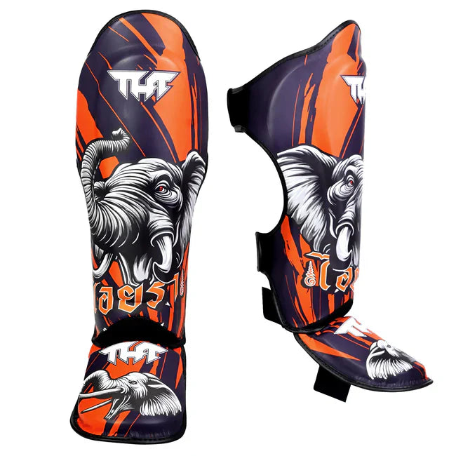Pair of elephant-themed shin guards with orange and black design on a white background